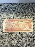 Front side of 1974 Canadian 2 dollar banknote showing Queen Elizabeth II portrait and denomination.