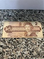 Front side of the 1986 Canadian $2 bill showing Queen Elizabeth II portrait and denomination markings.