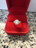 Ring displayed inside red velvet presentation box