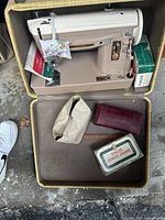 Overhead view of open hard case showing machine and accessories