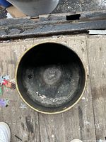 Top view of interior showing darkened aged brass surface with residue