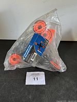 Photo of 4-sided jumping target in plastic packaging with product label showing orange targets and black frame.