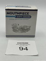 Box of anti-snore mouthpiece labeled 'Mouthpiece Anti-Snore Snore Solution Expert' with image of clear plastic mouthpiece on front.