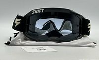 Front view of the black Shift dirt bike ATV goggles showing clear lens and logo on strap.