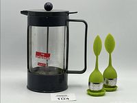 French Press and two leaf-shaped tea infusers with drip trays