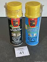 Two cans of Great Stuff foam insulation, one Big Gap Filler and one Window & Door, both with yellow caps and hazard warnings.
