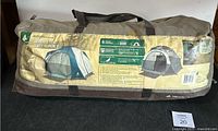 Photo of the Woods Huron 5 Person Tent carrying bag showing product information and images of the tent.