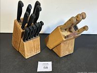 Two kitchen cutting tool sets with wooden blocks and knives with black and wooden handles