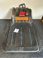 Set of two black all-season Motomaster car mats displayed with branded packaging showing key features and all-season use.
