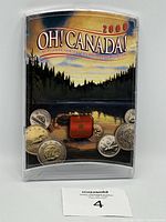 Front view of OH! CANADA 2000 Uncirculated Coin Set packaging showing scenic landscape with coins and maple leaf emblem.