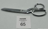 Full view of silver vintage Singer sewing scissors with ergonomic handles and straight blades.