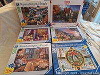 Photo showing all six Ravensburger puzzle boxes arranged to view front art and titles