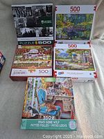 All five puzzle boxes displaying artwork and piece counts, showing very good condition and detailed images.