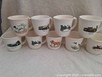 Nine stacked vintage cups showing different artwork of hunting dogs, antique cars, and steam locomotives arranged in two rows.