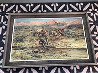 Full view of the framed vintage prospector art print depicting a man panning for gold with horses and mountains in the background.