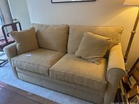 Front left perspective showing overall sofa and firm cushions