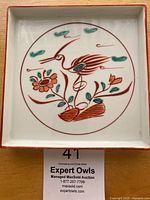 Front view of the square porcelain serving tray showing hand-painted red crane and flower design in Japanese Imari style.