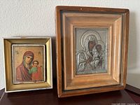 Both framed religious icons side by side