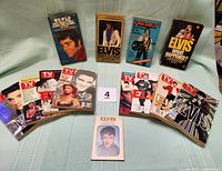 A group image showing 8 TV Guides with Elvis Presley on the covers displayed in a fan layout below 5 Elvis Presley books and one pamphlet standing upright on a neutral fabric background.