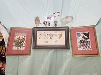 Photo showing two Gibson Gallery framed cat pictures with pink matting and several small figurines including a mouse and a frosted glass cat figurine.