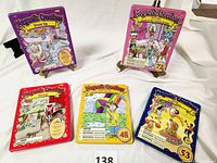 All five metal carrying cases with colorful themed lids showing their category and number of magnetic pieces included.