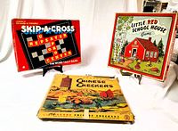 Photo showing Skip-a-Cross, Little Red School House, and Chinese Checkers board games.