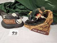 Overview photo showing the Miner and Hooded Merganser ceramic decanters side by side