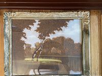 Frontal photo of the pastel painting featuring a tree landscape in a decorative wood frame with gold accents.