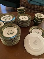 Overview of set showing stacks of dinner plates, salad plates, small plates and cups.