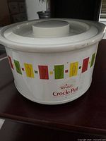Side view of the Mini Rival Crock-Pot showing colorful geometric retro pattern on white ceramic