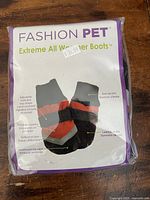 Front packaging showing brand, features such as adjustable straps, knit rib trim, leather sole.