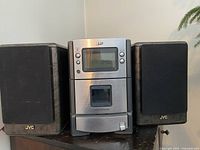Front view of JVC CD player and two speakers placed side by side
