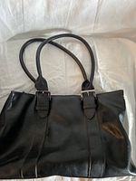 Black leather Kenneth Cole handbag with two handles, visible silver buckle hardware