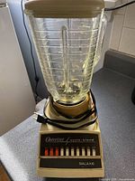 Retro Osterizer Galaxie blender front view showing the control panel and glass pitcher with lid.