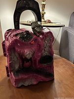 Front angle of vintage Snake Mountain playset showing the snake and skull face with orange eyes and a cavern opening at the base.