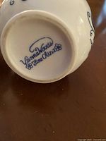 Bottom of china piece with Vienna Woods Fine China maker mark in blue ink.