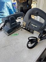 Photo of Mastercraft corded drill and sander side by side on a table, showing power cords and overall condition.