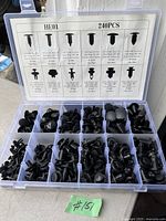 Photo of open organizer box containing 240 black plastic automotive fasteners sorted into compartments. Lid shows printed chart detailing each fastener type with sizes and quantities.