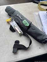 Photo of the Onyx M16 belt pack inflatable life jacket showing the compact carrying pack with attached belt strap, inflator, and gas cartridge.