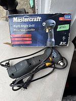 Photo of Mastercraft Right Angle Drill with original box showing brand, drill type, and model info.