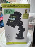 Box front showing Universal Pro-Mount window mount cell phone holder with an image of the holder clamping a phone and mounted to a car window.