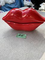 Red lips shaped vintage telephone with black handset on table