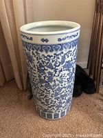 Photo showing the full umbrella stand with blue and white Chinoiserie pattern including floral and heart motifs.