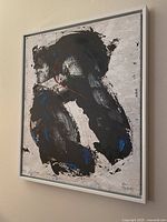 Front view of the abstract painting showing black, blue, white, and red colors with white frame.