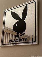 Front angle showing entire square mirror with black Playboy bunny logo and text.