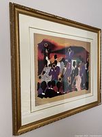 Angled view of framed Big Band print showing vibrant musicians and instruments with gold frame.