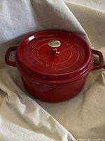 Red enameled cast iron round cocotte with lid closed