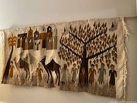 Front view of vintage Kilim wall hanging rug showing the full rectangular scene with animals, trees, houses, and human figures.