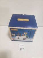 Closed box showing Lemax brand and preview image of the skiing holiday scene Christmas village set.