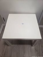 Top view of the white square side table showing clean surface and square shape.